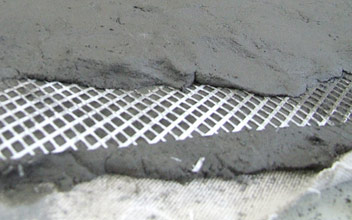 Reinforcing glass-fiber mesh between the layers